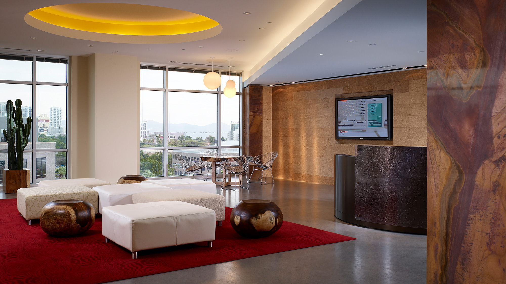 A living room with a red rug.