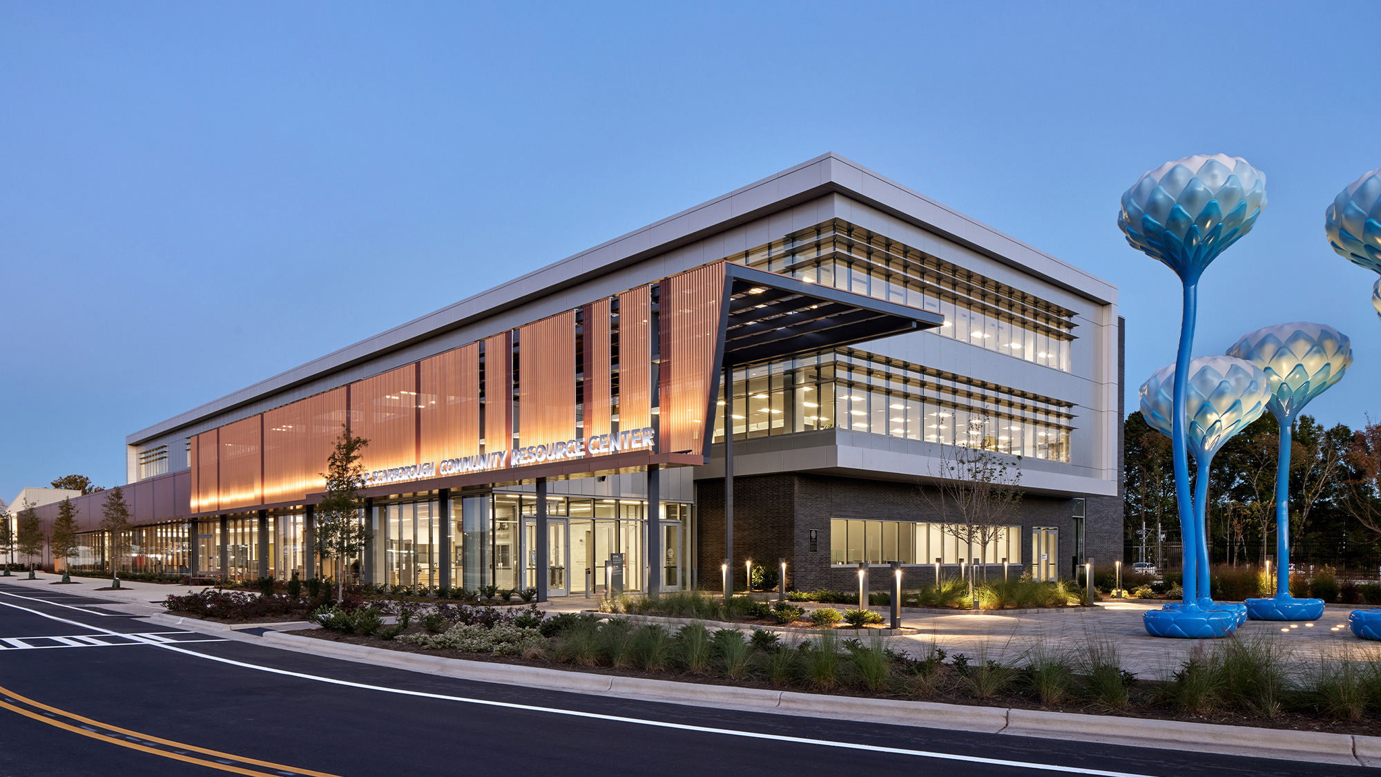 A building with a blue statue in front of it.
