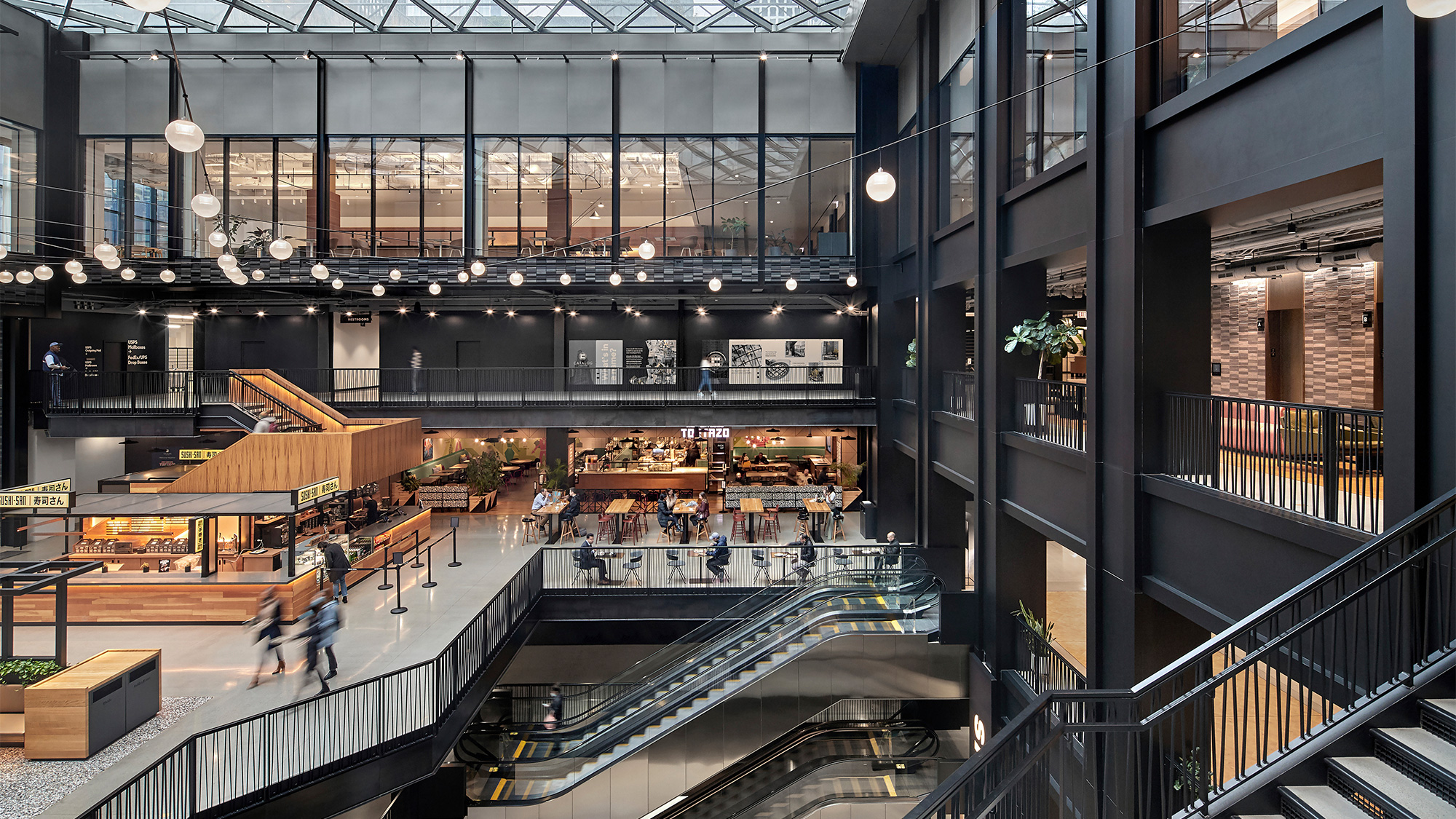 A large building with stairs and people.