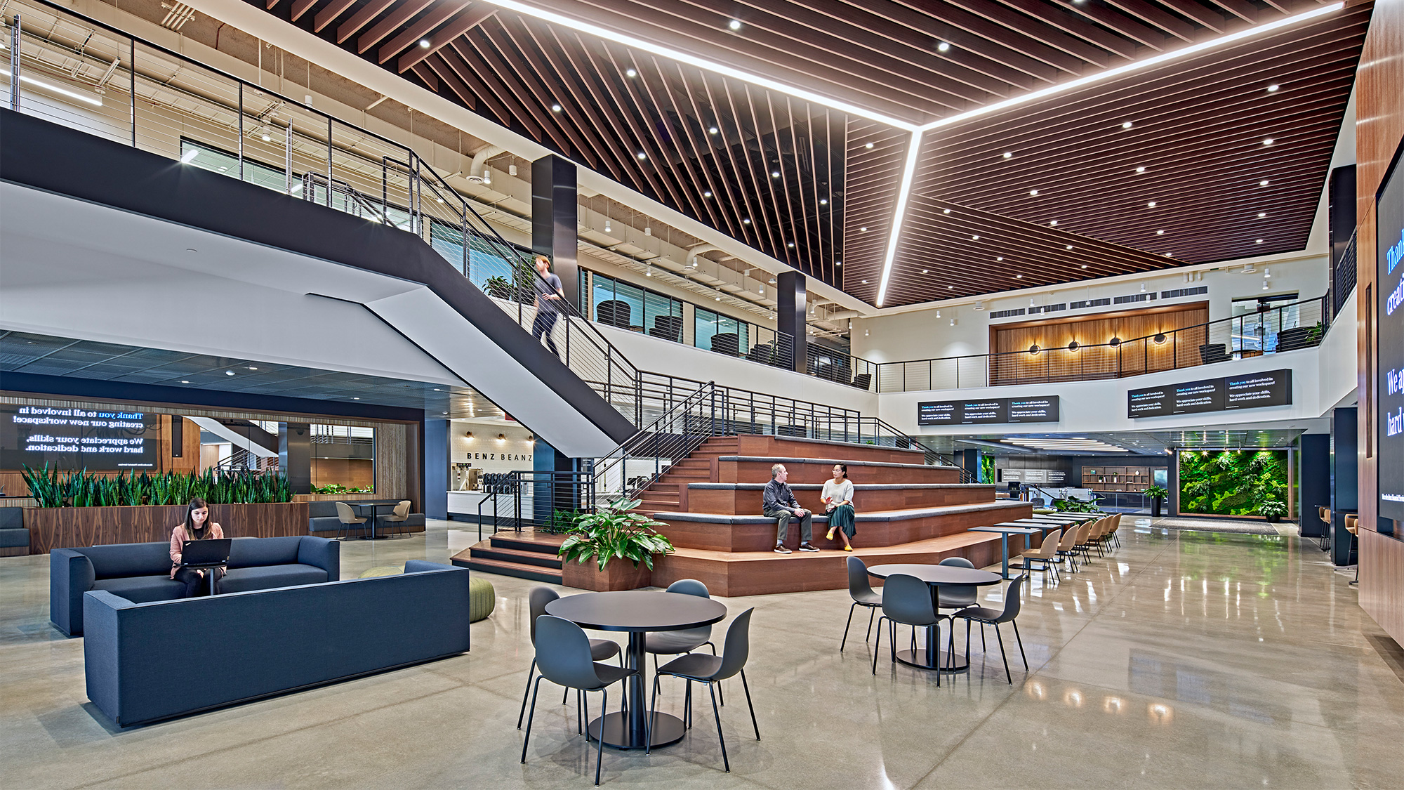 A room with a couch and chairs.