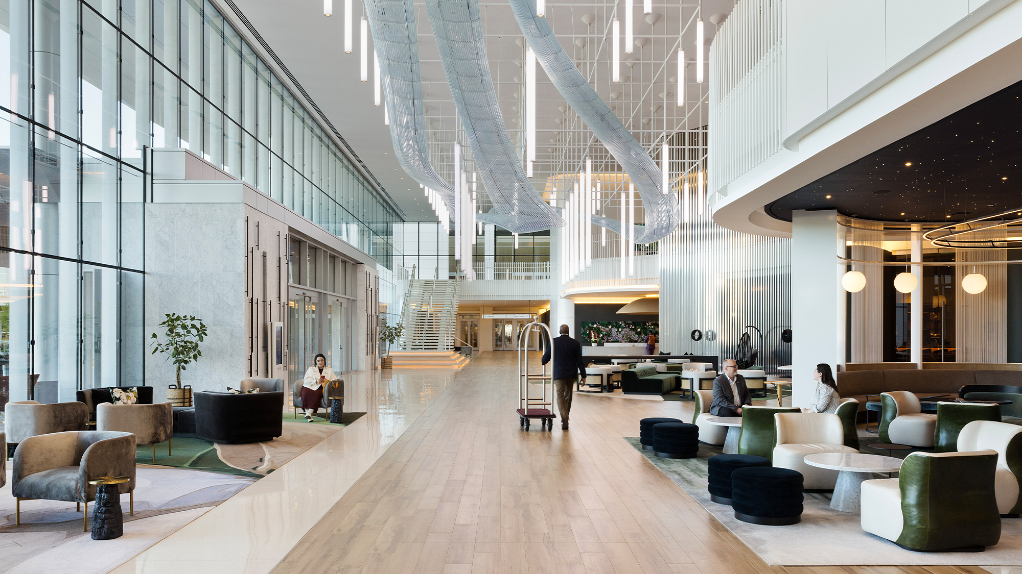 A large room with a few people.