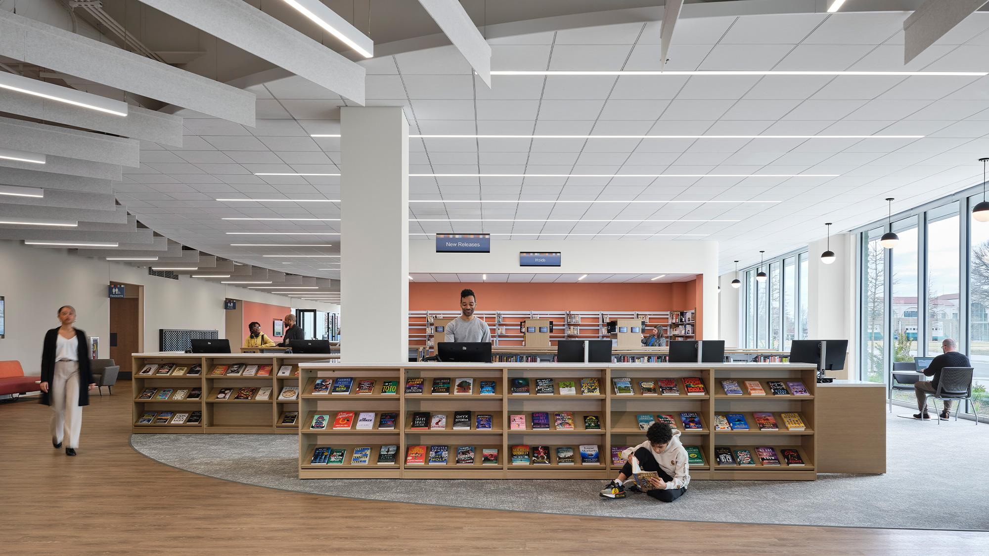 A few people in a library.