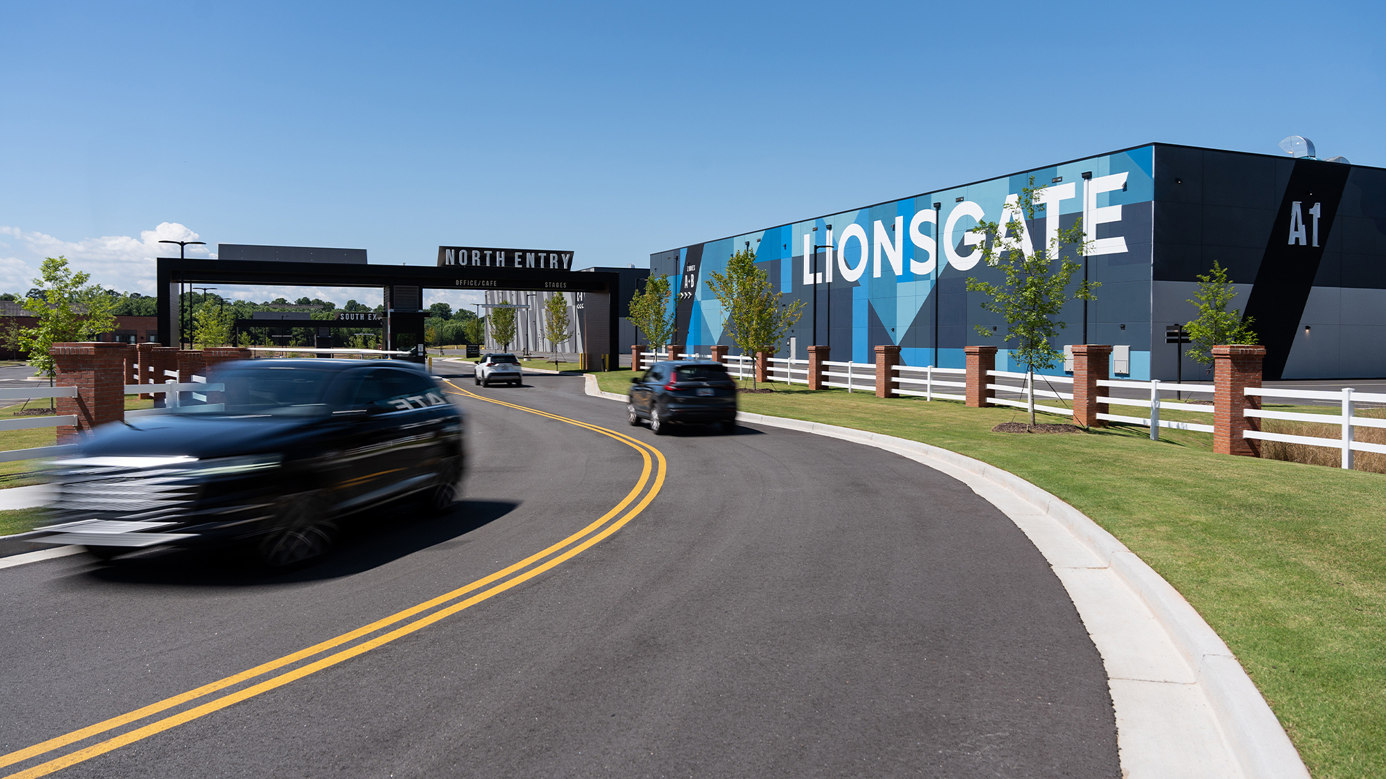 A road with cars on it and a building in the back.