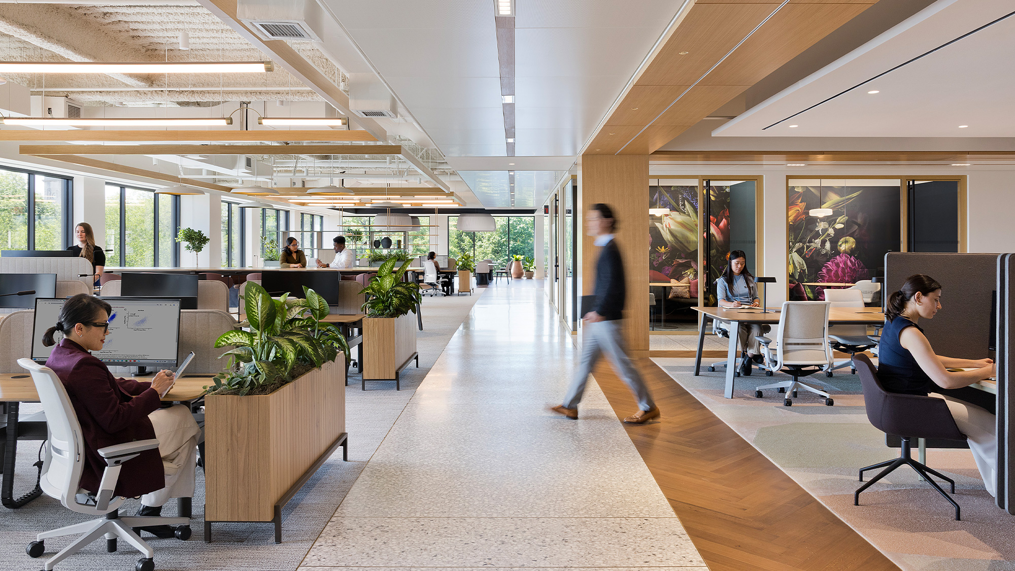 A person walking in a large office.