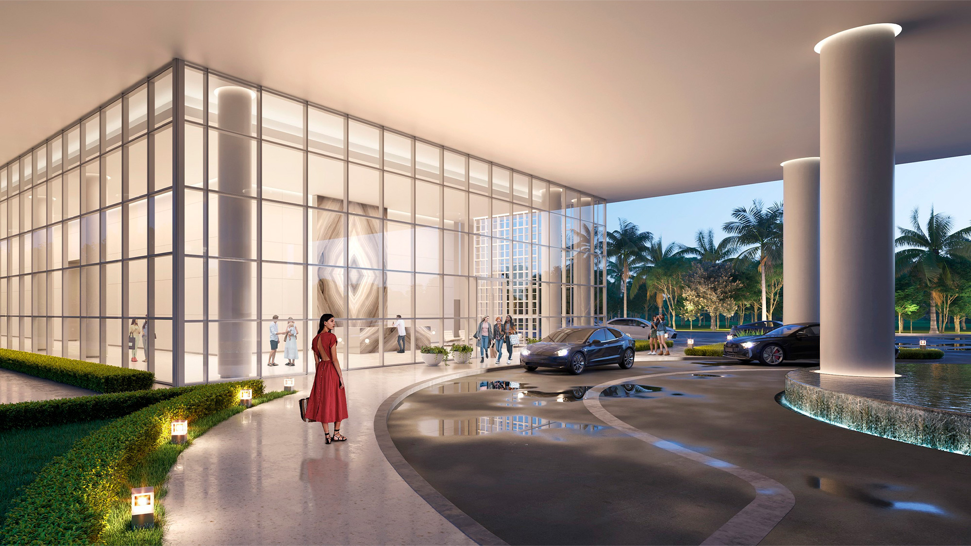 A person in a red dress standing outside a building.