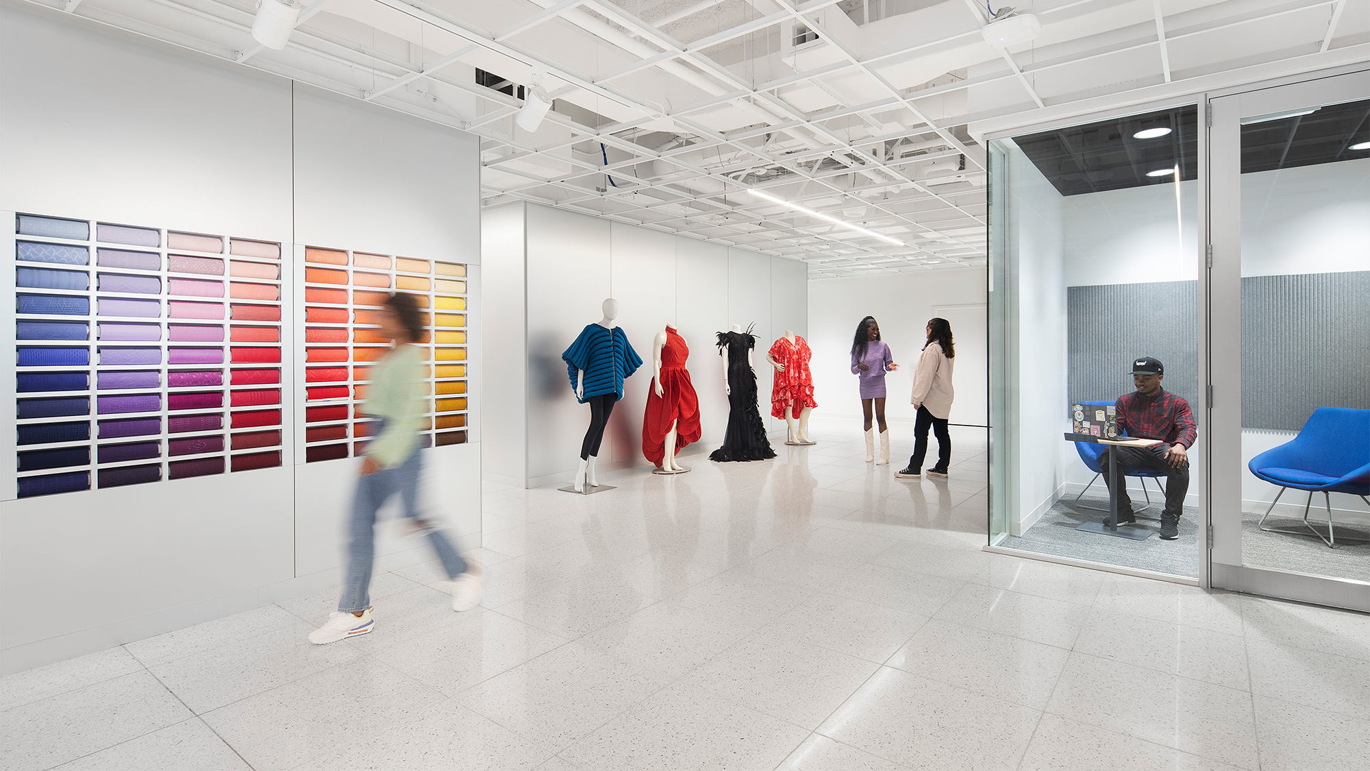 A group of people walking in a room.