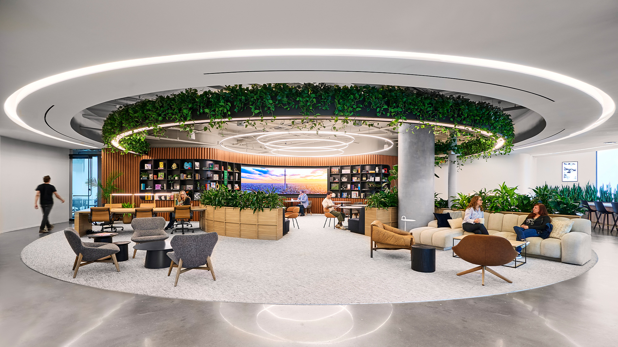 A large room with a large chandelier and people sitting in it.